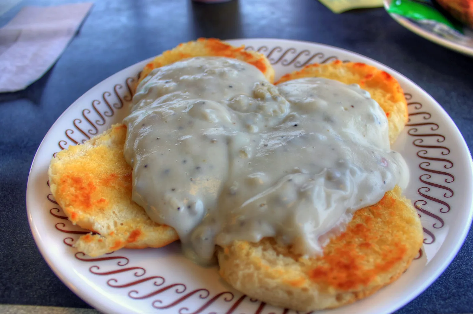 Biscuits and sausage gravy on a plate.