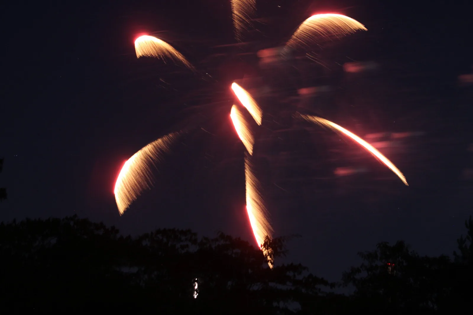 Fireworks burst over the treeline at a Fourth of July show at Alabama Adventure in Bessemer, west of Hoover.