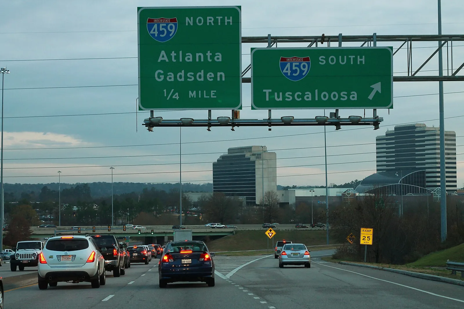 Overhead signs for the I-459 ramps on southbound U.S. 31 in Hoover, with office towers beyond.