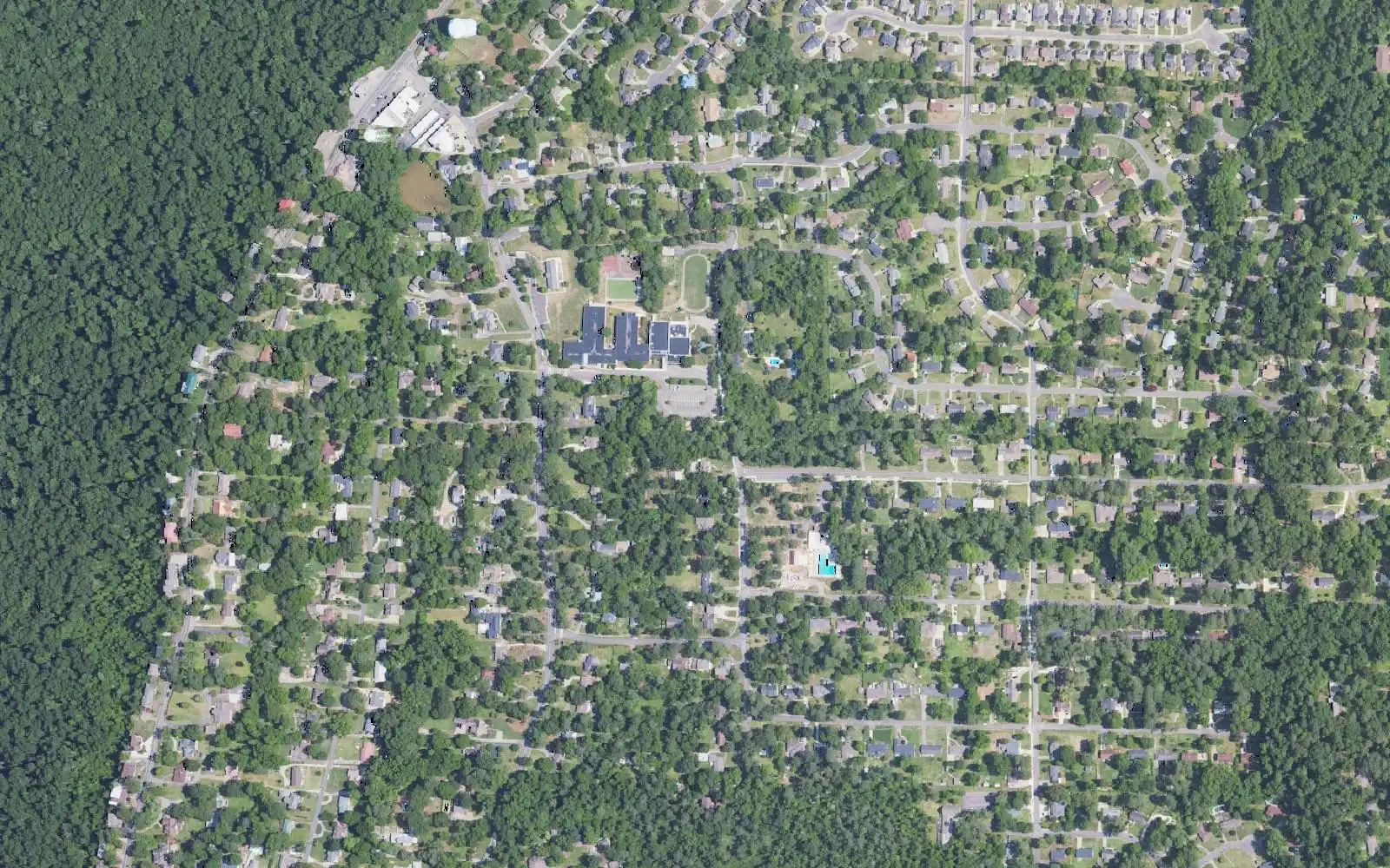 Aerial view of the wooded streets of Bluff Park on top of Shades Mountain, around Bluff Park Elementary School.