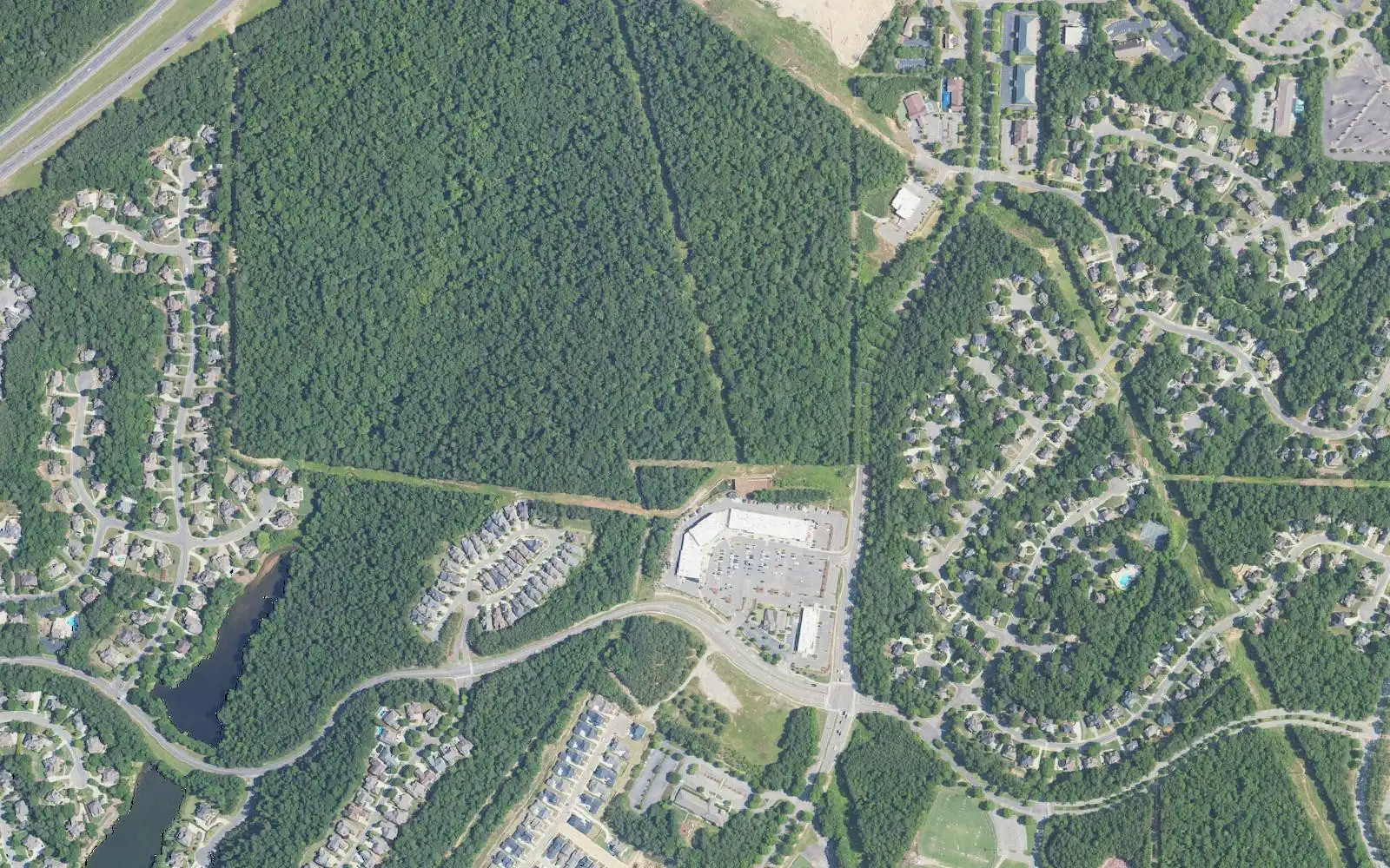 Aerial view of homes in Trace Crossings, south of I-459 in west Hoover, with a shopping center at upper right.