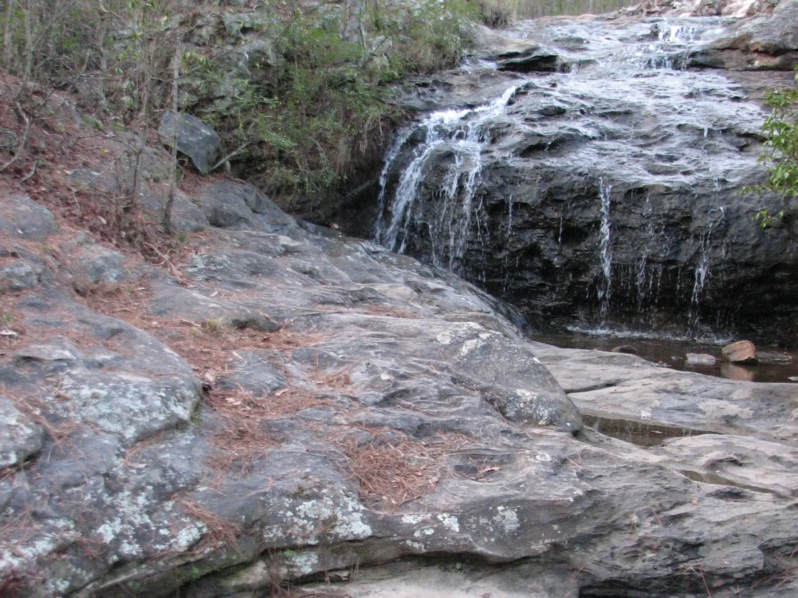 Water spills over sandstone ledges at the waterfall in Moss Rock Preserve in Hoover.