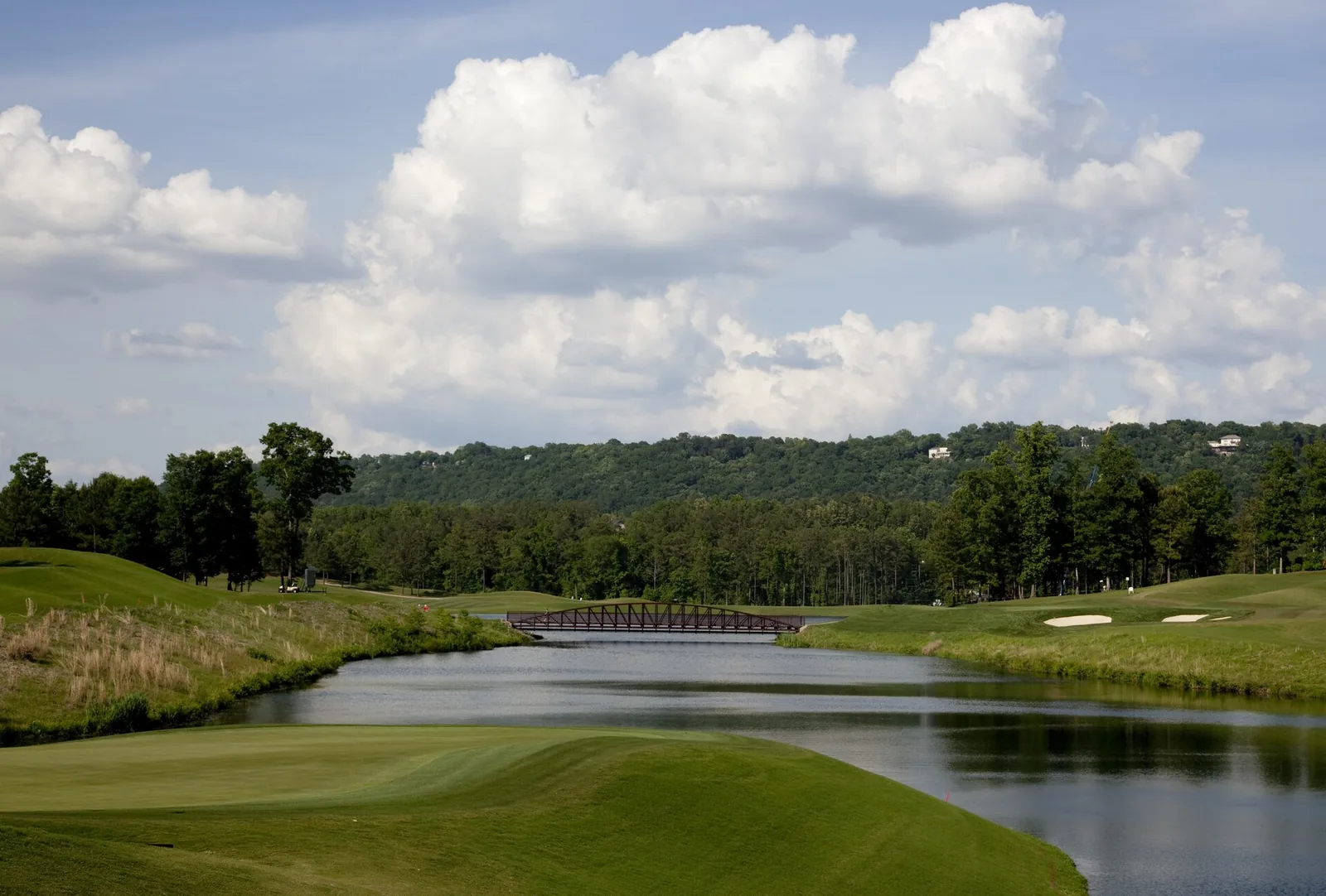 A footbridge crosses a lake on the Ross Bridge golf course in Hoover.